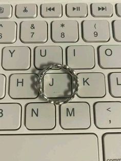 a metal ring sitting on top of a computer keyboard