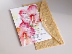 a piece of paper with flowers on it next to a roll of burlock