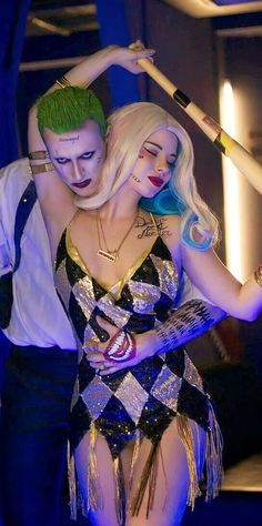 two people dressed up as the joker and harley in a dance pose with their arms around each other