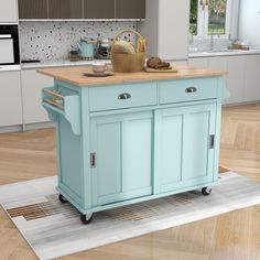 a blue kitchen island sitting on top of a wooden floor next to a white rug