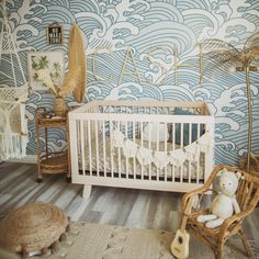 a baby's room decorated in blue and white waves