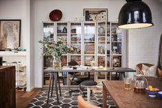 a living room filled with furniture next to a dining room table and bookshelf