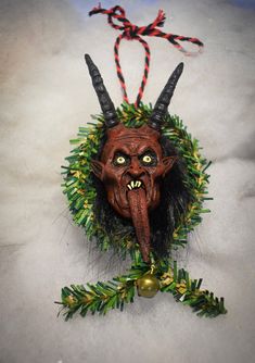 an ornament with horns and green leaves on it