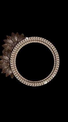 an ornate gold and diamond brooch with leaves on the side, set against a black background