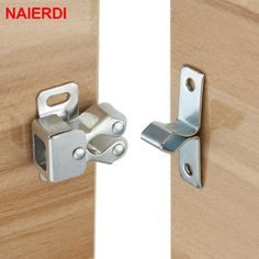 a pair of metal latches on wooden doors