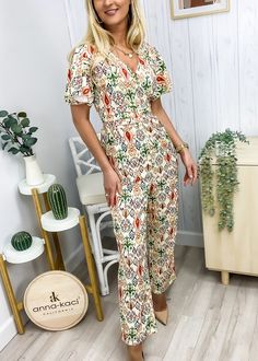 The Emes Shop jumpsuit is detailed with a fancy geometric print. Features a surplice neck line. flutter sleeves. straight leg silhouette. and regular fit. Pair it with a fedora hat and sandals for a chic look.MATERIAL:95% Polyester 5% SpandexMEASUREMENTS: Product Length 56"-57.5"in 4-6-Small | Waist: 25"-26.5"in | Chest: 33"-34.5"in | Hips: 33.5"-35"in 6-8-Medium | Waist: 26.5"-28"in | Chest: 34.5"-36"in | Hips: 35"-36.5"in 8-10-Large | Waist: 28"-29.5"in | Chest: 36"-37.5"in | Hips: 36.5"-38"in Fitted Patterned Summer Jumpsuits And Rompers, Summer Workwear Jumpsuits And Rompers With V-neck, Fitted Patterned Jumpsuits And Rompers For Summer, Elegant Short Sleeve Jumpsuits And Rompers For Vacation, Elegant Short Sleeve Jumpsuits And Rompers For Beach, Elegant Short Sleeve Beach Jumpsuits And Rompers, Summer Workwear Printed Jumpsuits And Rompers, Eatonton Georgia, Jumpsuit With Sleeves