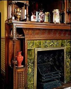 an old fireplace with many vases on it