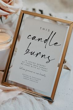 a candle burns sign sitting on top of a table