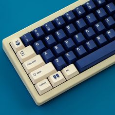 a computer keyboard sitting on top of a blue table