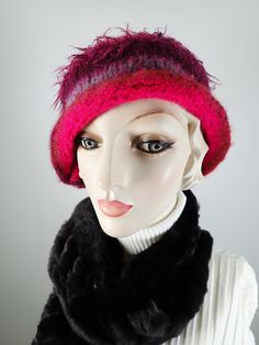 Add some warmth and whimsy to your fall and winter wardrobe with this fun hand knitted boiled and felted 100 percent wool warm winter cloche. This cute wool hat will keep you warm! Dress it up with an oversize shawl or throw it on with a jean jacket. Colors include fuchsia pink, rust and blue with other colorful fun fibers that pop out of the felt for added texture. Embellished with two handmade silk rosettes topped with iridescent vintage glass buttons. Rolled asymmetrical brim for additional i Multicolor Winter Cloche Hat With Short Brim, Pink Wide Brim Mini Hat For Winter, Multicolor Wide Brim Cloche Hat For Winter, Pink Winter Bucket Hat, Pink Winter Bucket Mini Hat, Winter Wool Mini Hats, Whimsical Winter Hat With Short Brim, Pink Wide Brim Cloche Hat For Winter, Handmade Cloche Hat For Winter