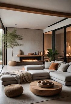 a living room filled with furniture and a fire place in the middle of the room