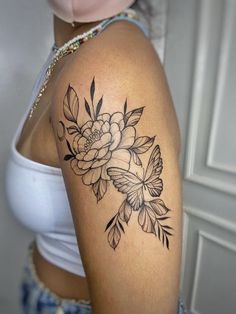 a woman with a flower tattoo on her arm