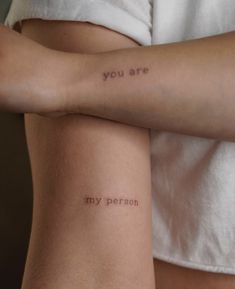 two people with tattoos on their arms that say you are my person and i am not