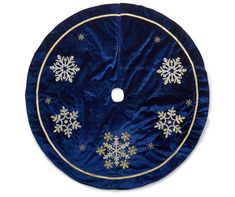 a blue and gold christmas tree skirt with snowflakes on the front, hanging from a hook