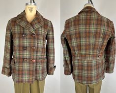 "You'll look the part of a ruggedly handsome outdoorsman in this toasty wool barnstormer jacket from the 1930s!  It's made of a thick wool woven into a bold plaid of hickory brown, rust orange, forest green, and beige.  There are two hand warmer pockets at the chest, two large pockets at the hip, double breasted leather knot button front closure, ventless belted back with pleats into the belt, and prominent notched collar.  Made by \"Double Duty.\"  This jacket is in great vintage condition with Vintage Single Breasted Pea Coat For Fall, Retro Tweed Jacket With Buttons For Winter, Retro Winter Tweed Jacket With Buttons, Vintage Single Breasted Fall Pea Coat, Vintage Single-breasted Pea Coat For Fall, Fitted Vintage Outdoor Outerwear, Vintage Single-breasted Fall Pea Coat, Vintage Fall Sport Coat With Button Closure, Vintage Sport Coat With Button Closure For Fall