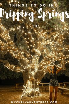 a woman standing in front of a tree with lights on it and the words things to do