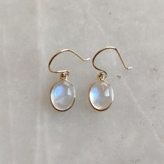 ITEM DESCRIPTION: >> The earrings are made from Solid 14K Yellow Gold. Gemstone used is absolutely natural and ethically sourced. >> Natural Rainbow Moonstone with bezel setting is studded on it with utmost precision. >> This is a minimalist design and is absolutely hassle-free and everyday jewelry. Gem: Rainbow Moonstone Gem size: 9x7 mm Gem weight: 4.70 carats Gold purity: 14K (58.33% approx.) Gold weight: 0.54 grams Gross weight: 1.48 grams The Gold purity is guaranteed and it comes with auth Classic Moonstone Jewelry With Gemstone, Classic Moonstone Gemstone Jewelry, Formal Yellow Gold Moonstone Jewelry, Silver Gemstone Earrings In 14k Gold Filled, Fine Jewelry 14k Gold Filled Gemstone Earrings, Delicate 14k Gold Gemstone Earrings, 14k Gold Filled Gemstone Drop Earrings, Elegant Moonstone Gemstones Gift, Teardrop Moonstone Jewelry In Yellow Gold