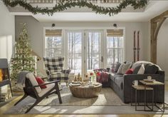 a living room filled with furniture and a christmas tree in the middle of the room