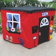 a red play house with windows and decorations on it