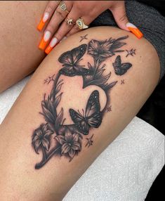 a woman's thigh with butterflies and stars on it