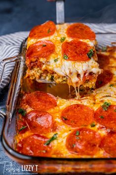 a slice of pepperoni pizza being lifted from a casserole dish