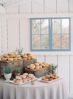 two wooden boxes filled with donuts on top of a table