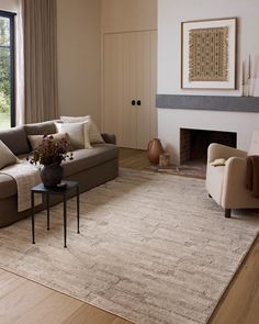 a living room filled with furniture and a fire place next to a large open window