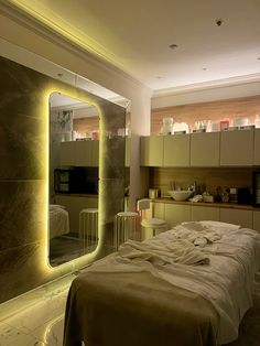 a bedroom with a large mirror on the wall and a bed in front of it