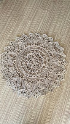 a white doily sitting on top of a wooden table