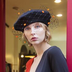 Black beret (50% Wool 50% Acrylic) with black veiling and red chenille dots, individually hand applied.  The veiling is soft with very large diamonds, in the style of the 1940s veils.  The idea of the berets with veiling comes from my desire to have a special hat that I could put in a trolley for short trips or in my purse while I'm in town, without ruining it.  You can hide most of the veil under the beret for a more sober effect. I'm happy to send more information or detailed pictures, please ask! Kindly add a contact phone number upon check-out, especially in case of priority shipping, it's required in the shipping documents.  For US and non-EU customers: I do accept returns but please keep in mind that shipping back to Italy could be expensive and you will be required to fill in docume Vintage Black Beret For Fall, Elegant Black Beret For Party, Black Fitted Beret For Fall, Fitted Black Beret For Fall, Elegant Black Beret For Fall, Beret With Veil, Orange Beret, Black Hat Women, Futuristic Mask