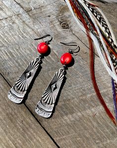 These Oxidized Silver Paddle earrings have a unique Southwestern design and true Western feel. Offering two different gemstone options: * Coin Red Coral * Coin Kyanite (beautiful hues of blue, bronze, and green) Total length = 2.5 inches Sterling Silver ear wire! Artisan Red Teardrop Earrings, Bohemian Concho Earrings As Gift, Southwestern Red Dangle Earrings, Southwestern Style Red Dangle Earrings, Red Southwestern Dangle Earrings, Artisan Red Drop Earrings, Artisan Red Dangle Earrings, Artisan Red Nickel-free Earrings, Red Bohemian Sterling Silver Earrings