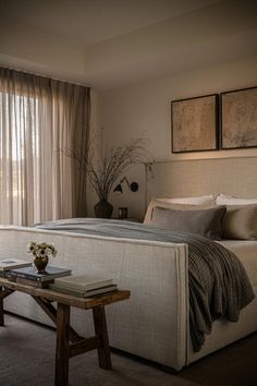 a large bed sitting next to a window in a bedroom