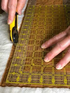 a person using a pair of scissors to cut fabric