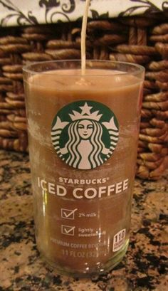 starbucks iced coffee is being poured into a glass on top of a granite countertop