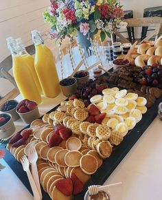 a table topped with waffles, fruit and other foods on top of it