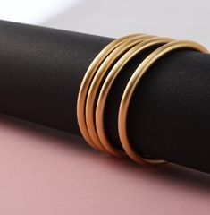 Complete your look with this exquisitely crafted Gold Plated Matte Bangle. Combining a sleek brass body and a luminous, matte gold coating, this timeless bracelet will become your go-to for elevating any ensemble. Its versatile design and water-proof and tarnish-free construction make it an ideal choice for everyday wear. A subtle hint of extravagance - perfect for creating an air of sophistication and luxury. Matte Gold Bangle Bracelet For Formal Occasions, Gold Matte Finish Jewelry Gift, Matte Finish Gold Jewelry Gift, Modern Matte Gold Bangle Bracelet, Minimalist Gold Jewelry With Matte Finish, Modern Gold Jewelry With Matte Finish, Minimalist Matte Gold Jewelry, Modern Matte Finish Gold Jewelry, Minimalist Matte Finish Gold Jewelry