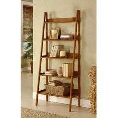 a wooden ladder shelf with books on it in a room next to a carpeted floor