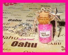 a bottle filled with pink liquid sitting on top of a table next to a star