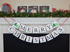 a christmas banner is hanging on the mantle