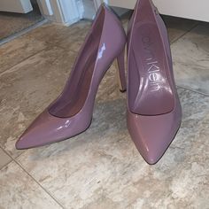 Very Beautiful Pumps, Too Big For Me Gentle Purple /Mauve Color, Stiletto Heel, Cute Logo On The Sides. Pointed Toes. Perfect For Business Look Or Dressing Up: Brand New, No Box. Purple Patent Leather Heels With Pointed Toe, Purple Fitted Heels With 4-inch Heel, Purple Synthetic Heels With 4-inch Heel, Luxury Purple Heels With 4-inch Heel, Purple Pointed Toe Heels With 4-inch Heel, Taupe Heels, Cute Logo, Purple Mauve, Calvin Klein Shoes