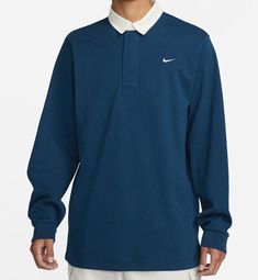 Elevate your athletic style with this Nike Sportswear Rugby Top Solo Swoosh. This blue collared polo shirt features a solid pattern and long sleeves, perfect for any casual occasion. Made with a comfortable knit fabric of 98% cotton and 2% spandex, this shirt fits regular with a size type of regular. It also boasts the iconic Nike Swoosh logo, representing the brand's top-quality performance and activity. This shirt is ideal for sports events or a day out and about. Get yours now! Nike Swoosh Logo, Concept Clothing, Athletic Style, Swoosh Logo, Nike Swoosh, Shirt Fits, Athletic Fashion, Rugby Shirt, Solid Pattern