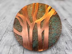 a metal plate with trees painted on it