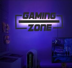 the gaming zone logo is lit up in purple and blue lights, along with a computer