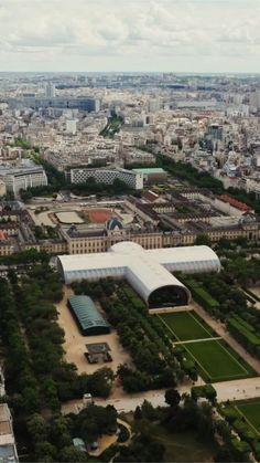 an aerial view of the city and its surrounding park, with buildings in the foreground