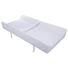 a baby crib mattress with white sheets on it's sides and straps around the edges