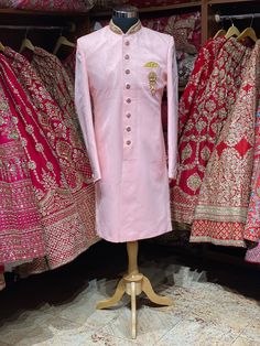 This taupe pink simple perfect attire for his perfect wedding event. This exquisite sherwani is enriched in zardozi, stones & thread on the mandarin collar and the designer buttons are rightly sufficing the attire. Available with matching chudidar. Size: 42, 44, 46 Ready to Ship! Pink Long Sleeve Sherwani With Dabka Work, Pink Bandhgala With Dabka Work, Formal Pink Bandhgala With Intricate Embroidery, Traditional Pink Long Sleeve Bandhgala, Traditional Long Sleeve Pink Bandhgala, Pink Resham Embroidered Bandhgala For Formal Occasions, Pink Embroidered Nehru Jacket Kurta, Pink Sherwani With Intricate Embroidery, Formal Pink Bandhgala With Resham Embroidery