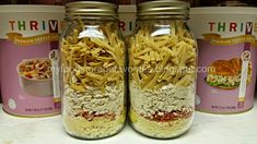 three jars filled with food sitting on top of a counter