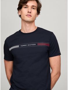 Tommy Hilfiger men's T-shirt. Made from lightweight cotton jersey, known for its breathability and stretch, our comfortable crewneck tee is cut in an easy fit and finished with our Tommy Stripe graphic.  Material: 100% Cotton. Adidas Cotton T-shirt With Three Stripes, Adidas Cotton Short Sleeve T-shirt, Cotton T-shirt With Three Stripes Branding, Crew Neck, Adidas Cotton Crew Neck T-shirt, Graphic Tee With Three Stripes, Crew Neck, Graphic Tee With Three Stripes Branding And Crew Neck, Modern Branded Crew Neck T-shirt, Modern Crew Neck Top With Text Print, Tommy Hilfiger Cotton T-shirt With Text Print