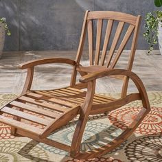 a wooden rocking chair sitting on top of a rug