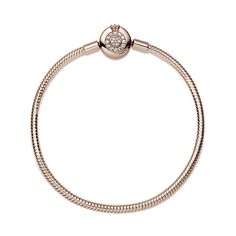 Bring some sparkle to every moment with the Pandora Moments Sparkling Crown O Snake Chain Bracelet. Hand-finished in 14K rose gold-plating, the bracelet's clasp features the iconic Pandora crown O monogram and bead-set clear cubic zirconia pavé, while the snake chain brings a chic and modern touch to your wrist. Stack it with other bracelets and load it up with favorite charms for a piece you'll reach for over and over. Rose Gold Charm Bracelet With Jubilee Bracelet, Rose Gold Charm Bracelet With Jubilee Detail, Rose Gold Jubilee Charm Bracelet, Luxury Sparkling Rose Gold Jewelry, Luxury Rose Gold Bracelets With Sparkling Stones, Rose Gold Round Bracelets With Charms, Elegant Rose Gold Bracelets With Charms, Luxury Rose Gold Diamond Bracelet With Sparkling Stones, Rose Gold Diamond Bracelet With Sparkling Stones